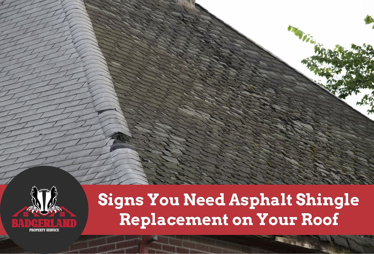 Damaged asphalt shingles on a house roof needing replacement.